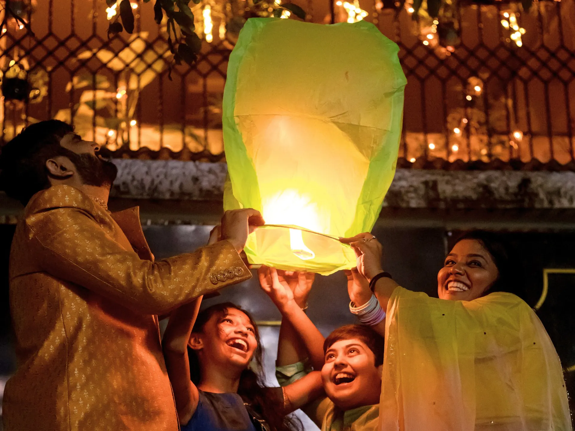 A happy family lights a lantern