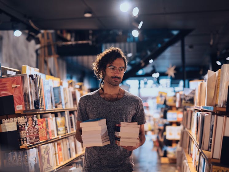 Man browsing books at the Berkelouw Paddington book store on Oxford Street, Paddington