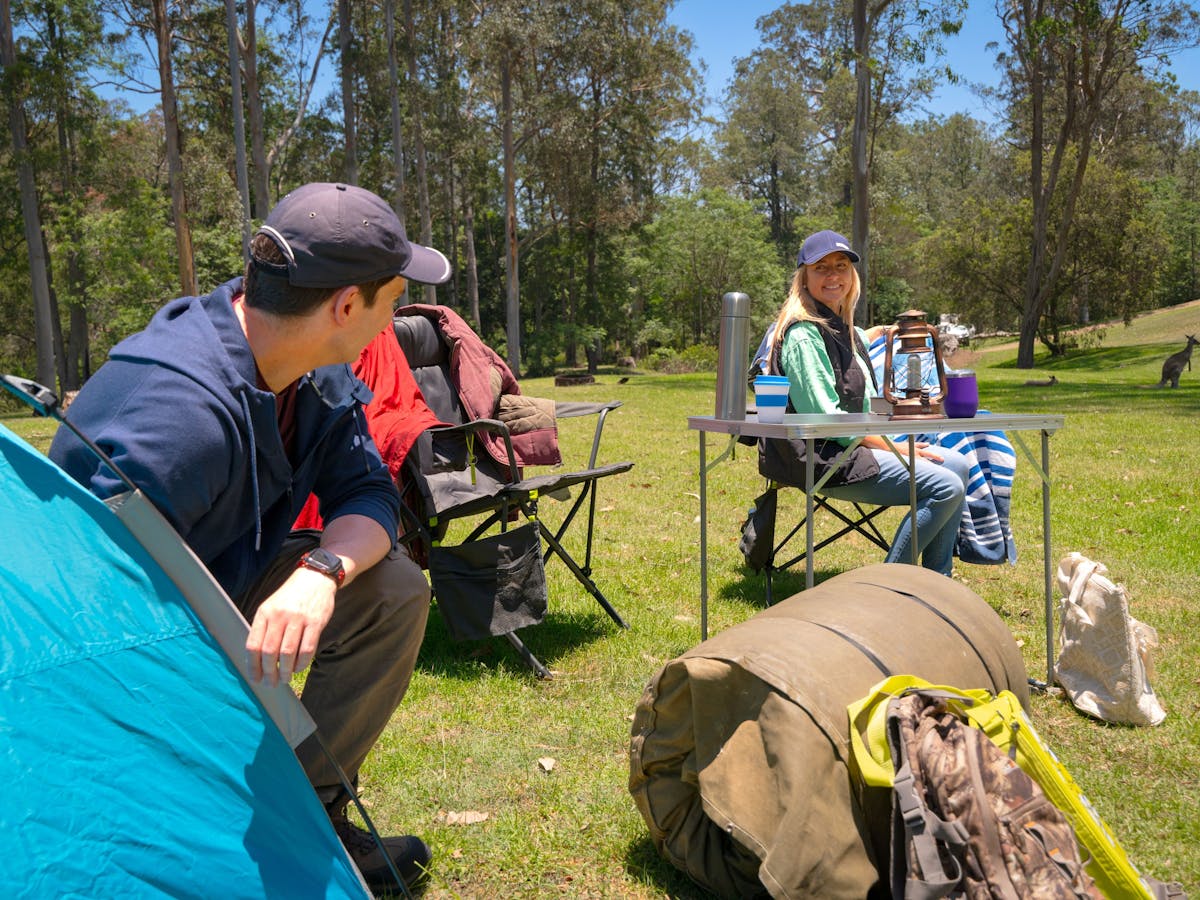 Couple camping with tent and swag in the bush