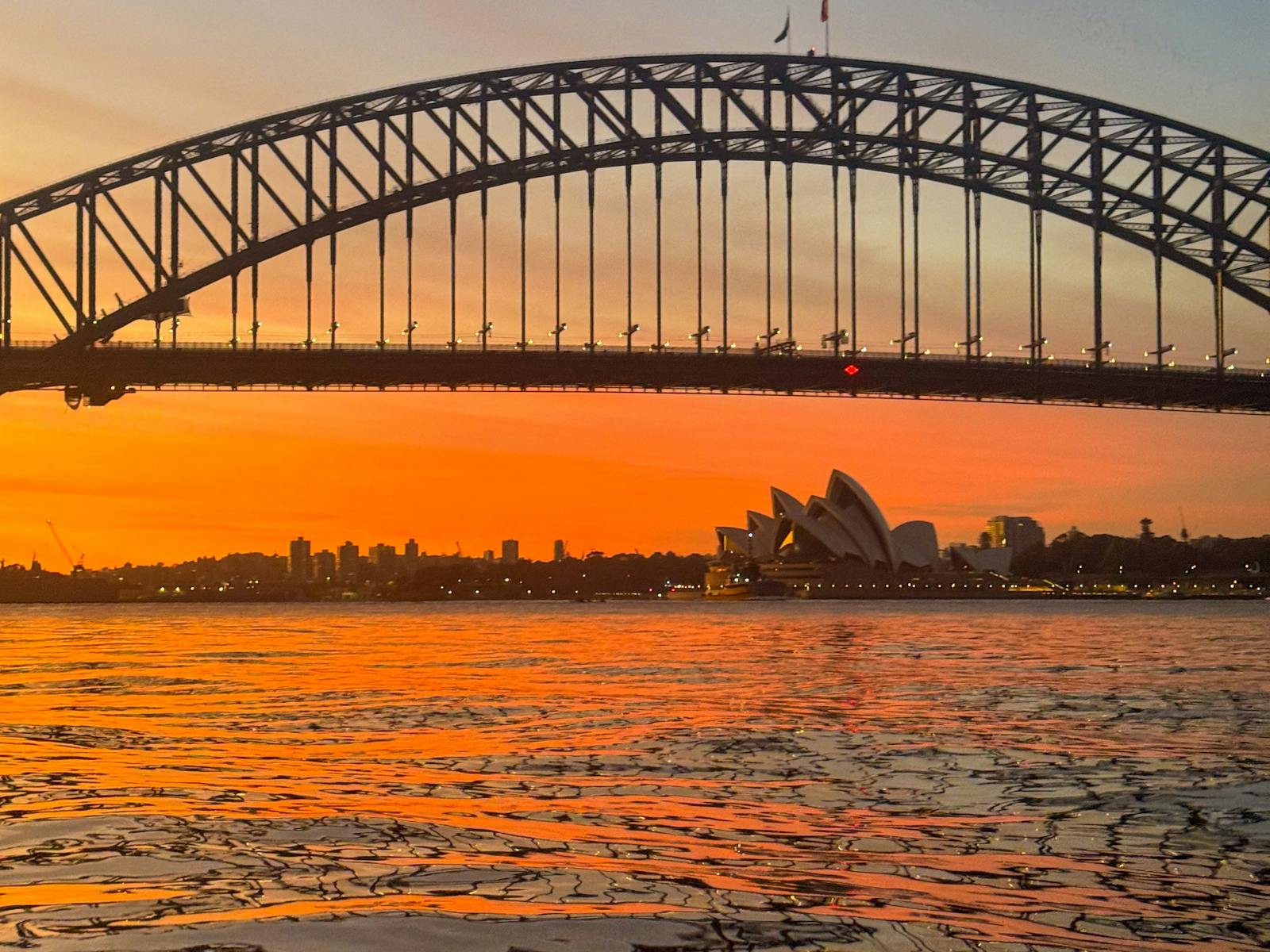 A beautiful portrait photo form a kayak of Sydney Harbour with sydney harbour bridge and opera house