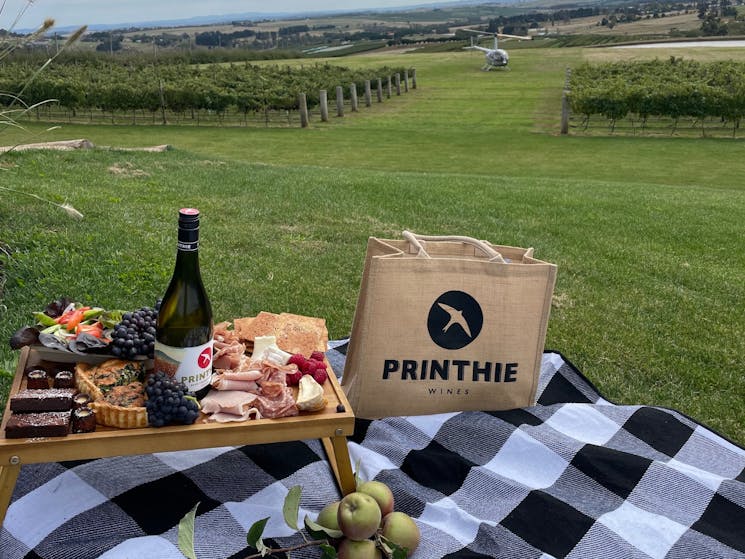Printhie Picnic food set-up on tray table near a vineyard