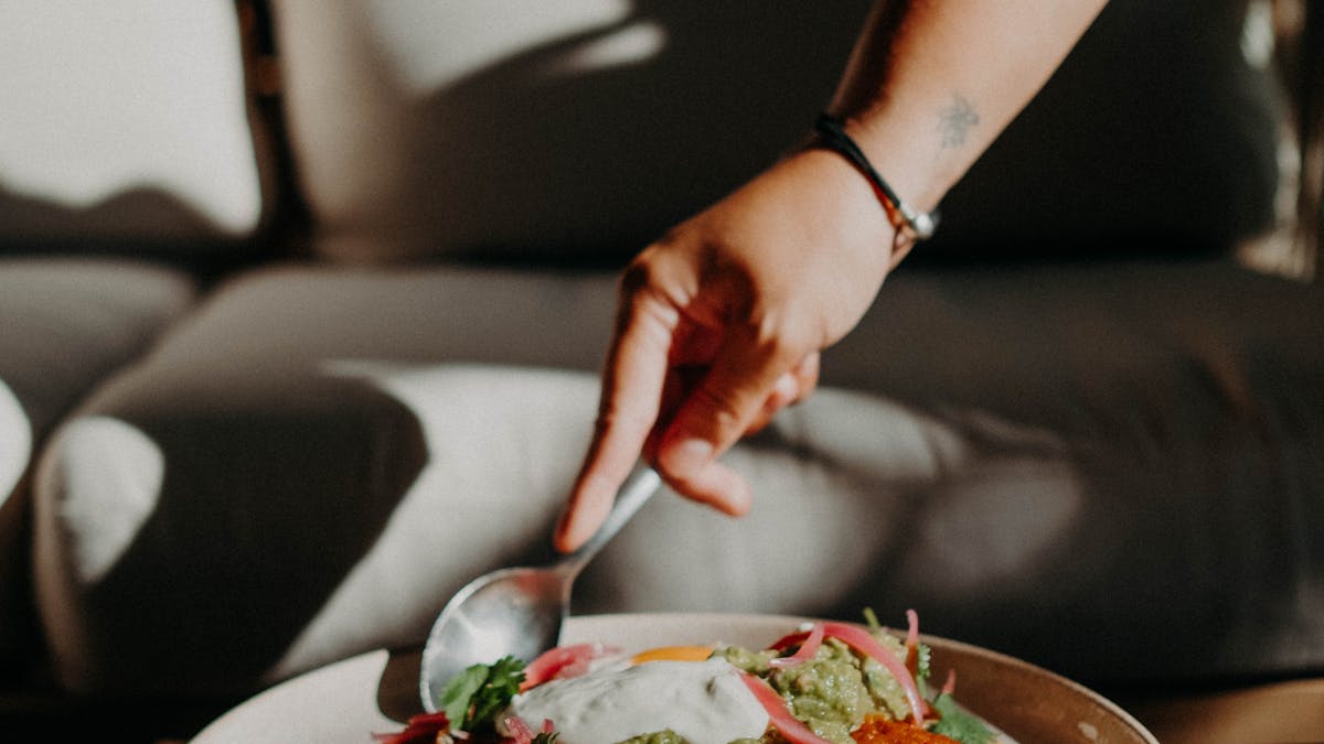 A friendly person eating huevos rancheros for brunch