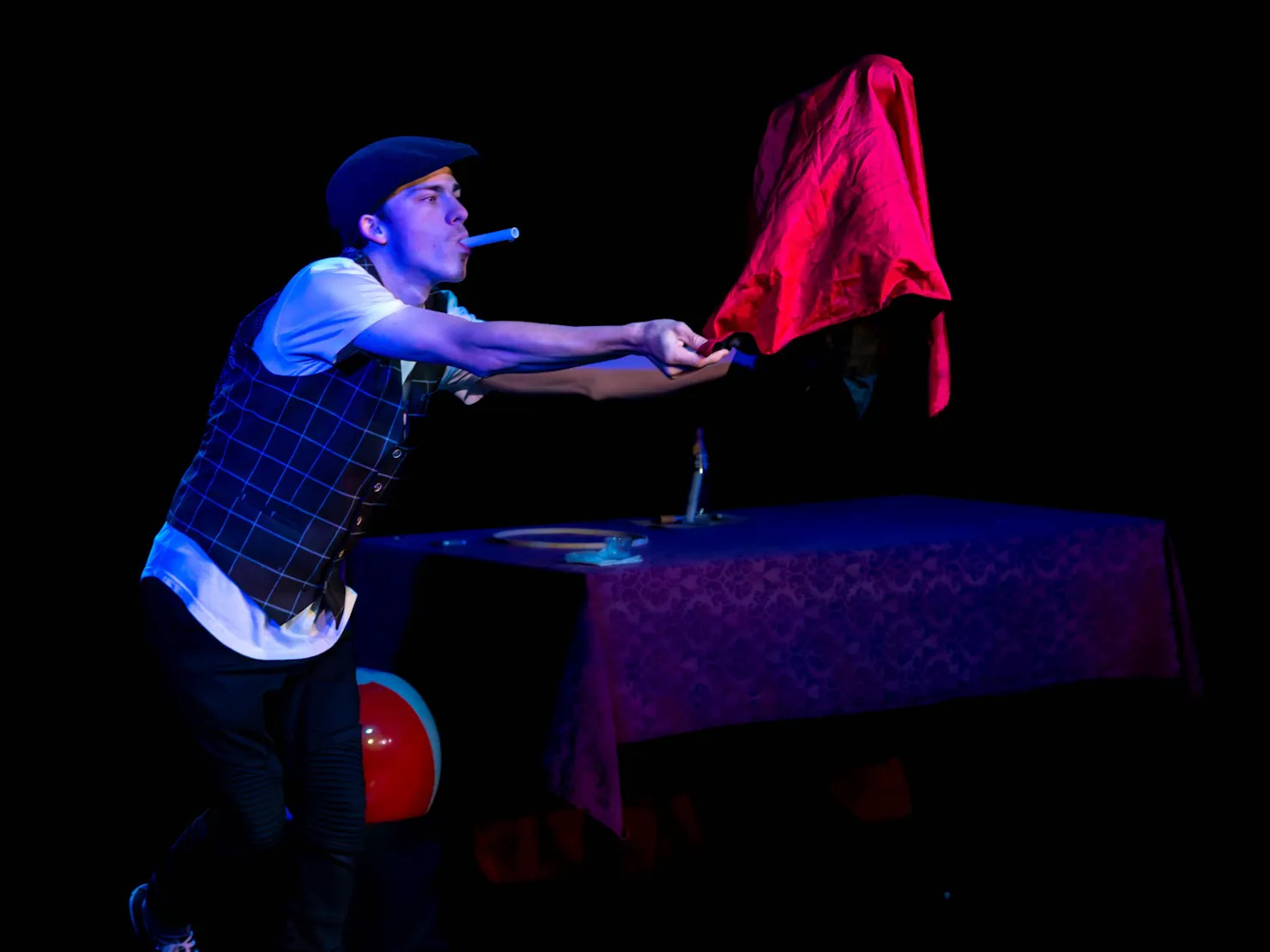Aiden floating a bubble under a red cloth