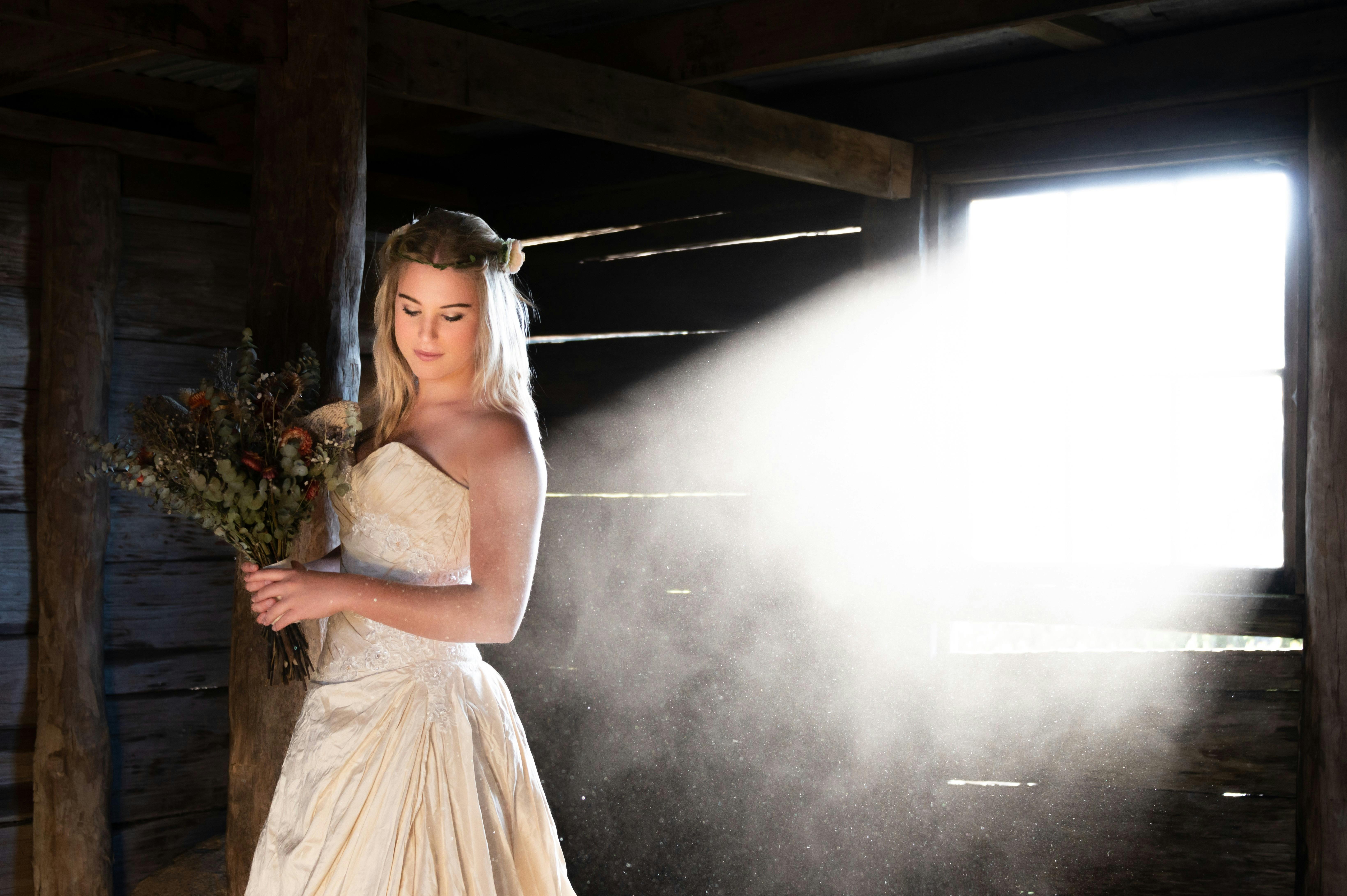 A bride is taking a moment inside the rustic Craig's Hut.
