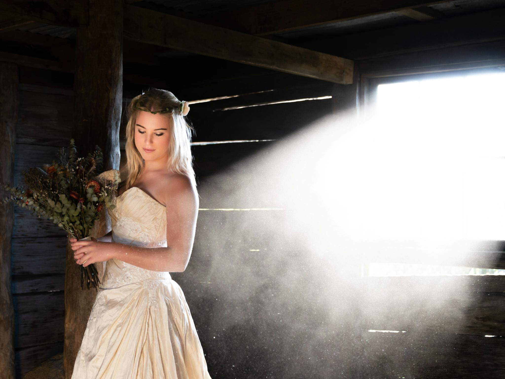 A bride is taking a moment inside the rustic Craig's Hut.