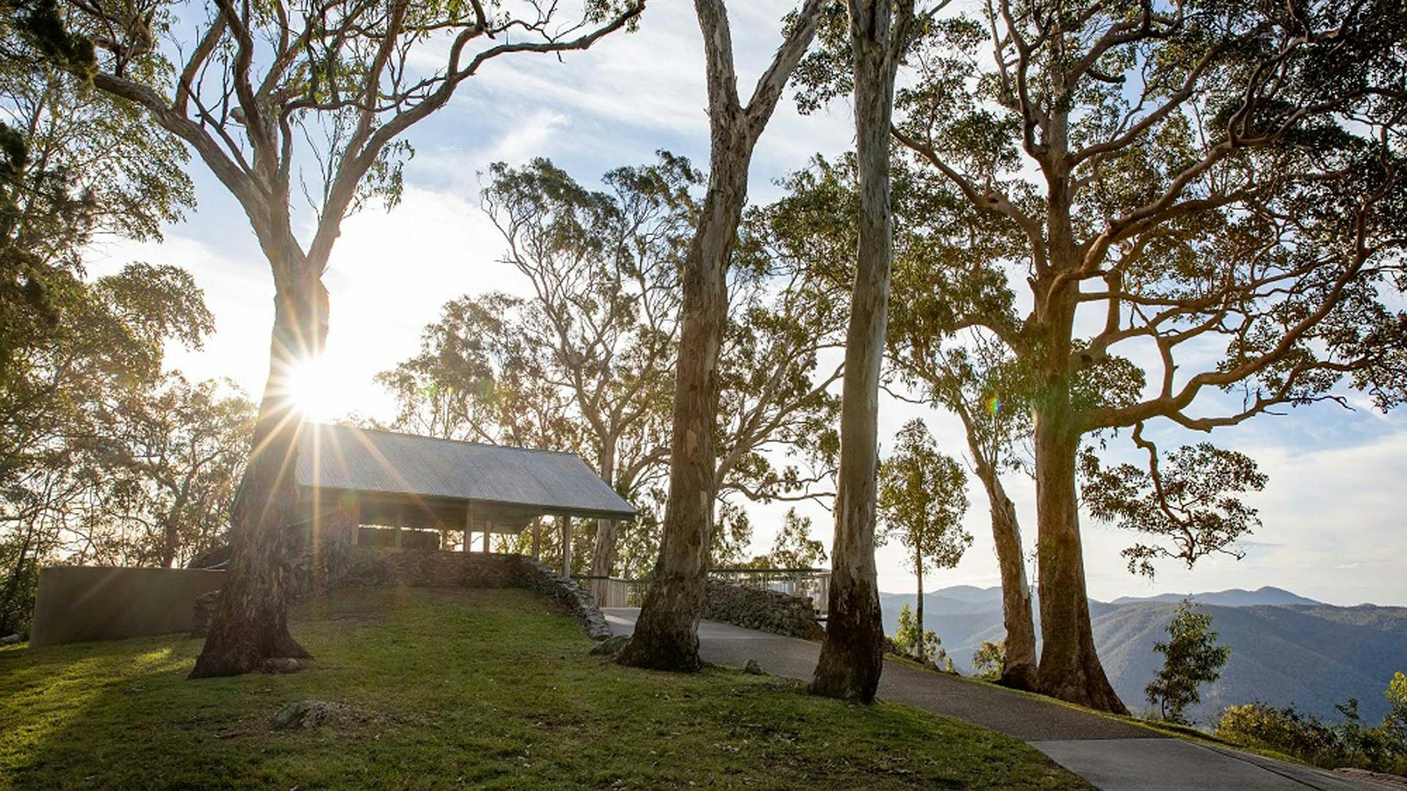 Picnic hut surrounded by trees at Jolly's lookout during at sunset