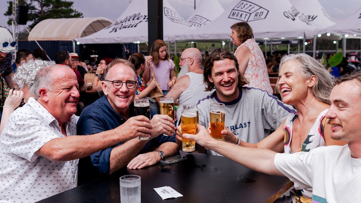group shot of friends saying cheers with beers in hands