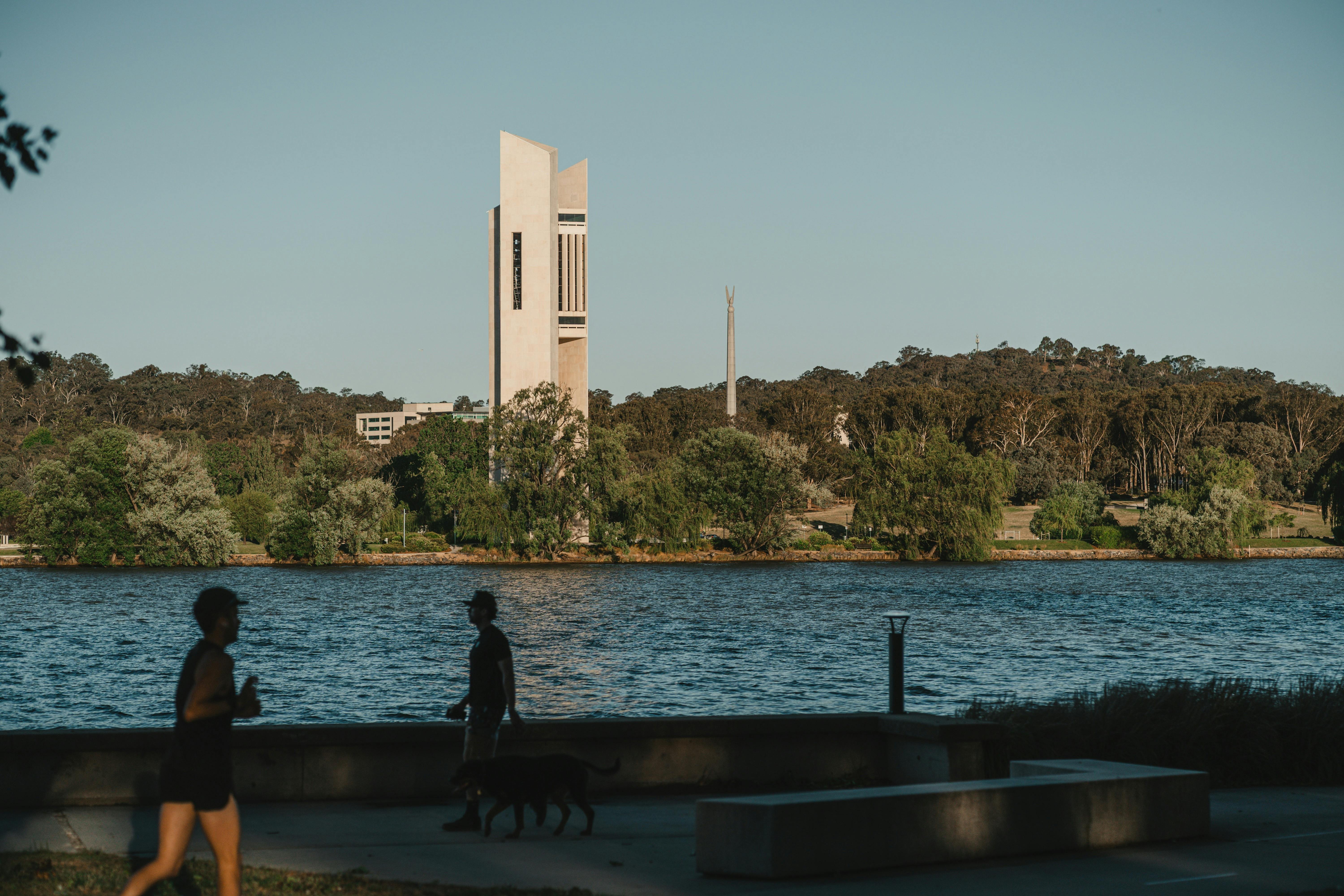 A body of lake with monuments in the background