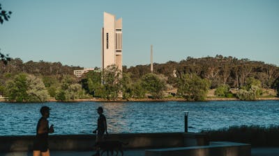 A body of lake with monuments in the background