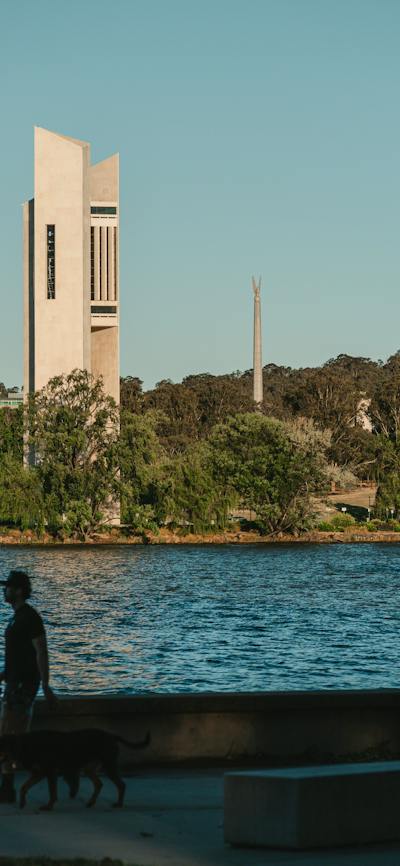 A body of lake with monuments in the background