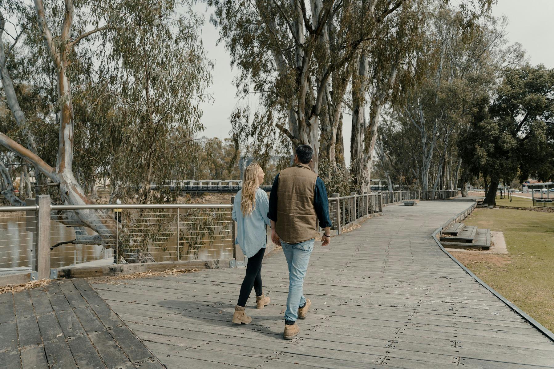 Couple walking the Koondrook Barham  Redgum Statue River Walk
