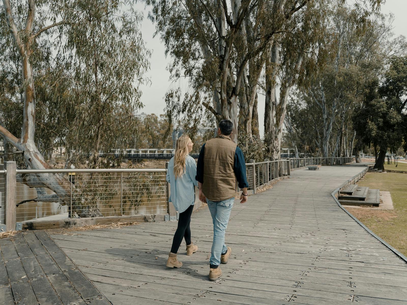 Couple walking the Koondrook Barham  Redgum Statue River Walk