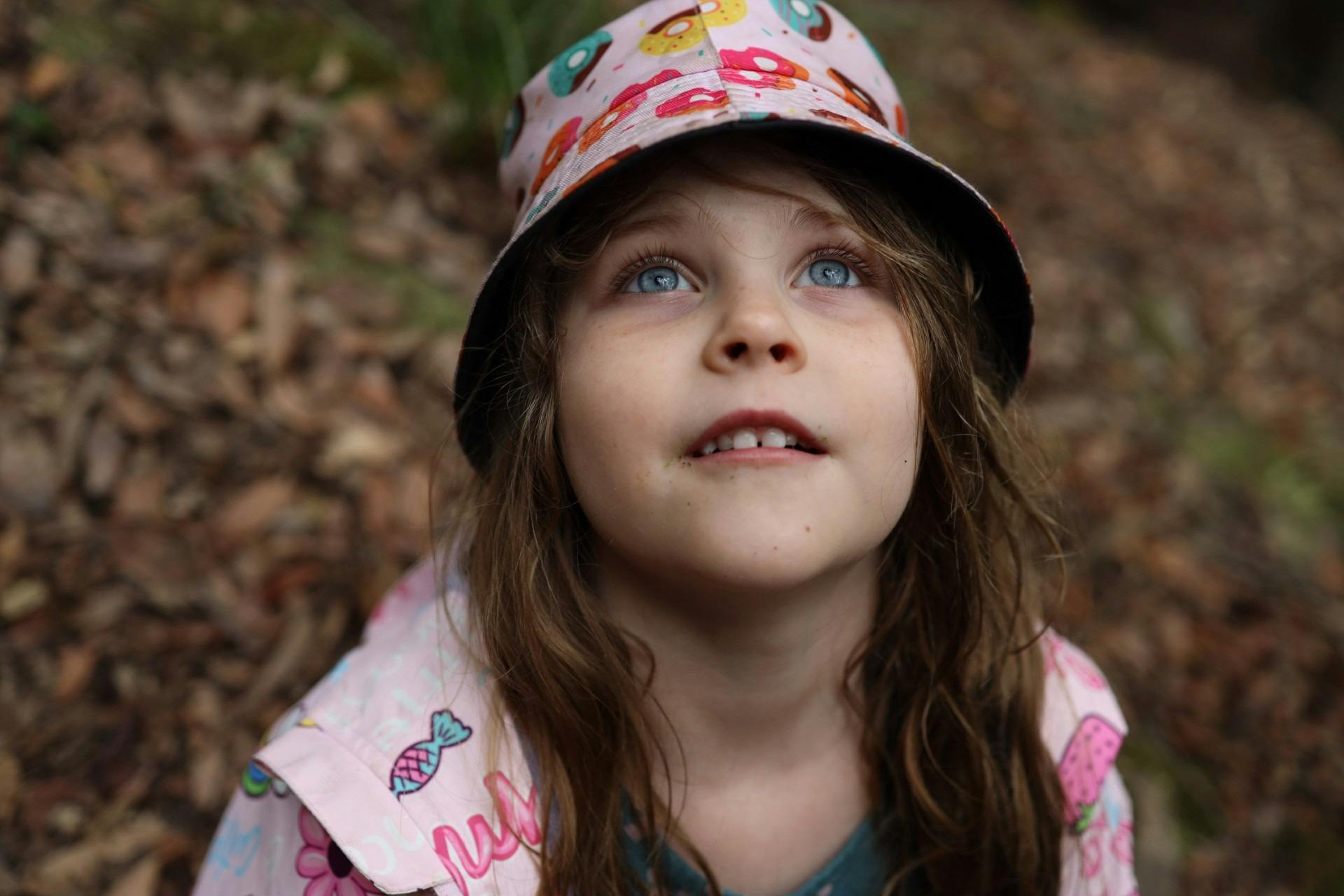 Young girl focusing up in nature