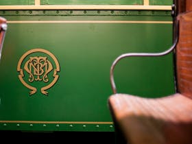 Side view of tramcar, featuring distinctive monogram crest of the Melbourne and Metropolitan Tramway