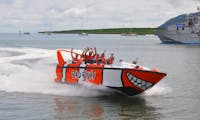 Guest on Bad Fishy Jet Boat Smiling and waving as they speed by in Cairns Tropical North Queensland