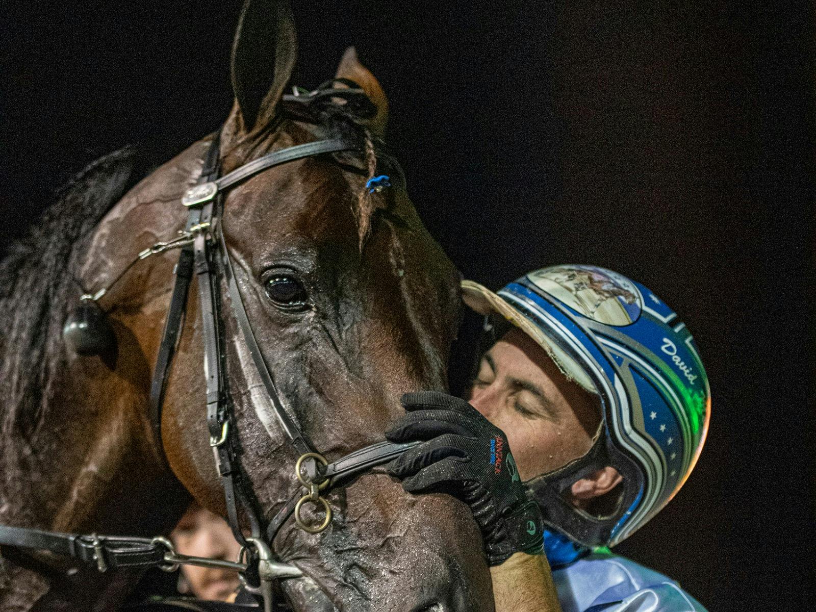 Jockey giving horse a hug at Club Menangle