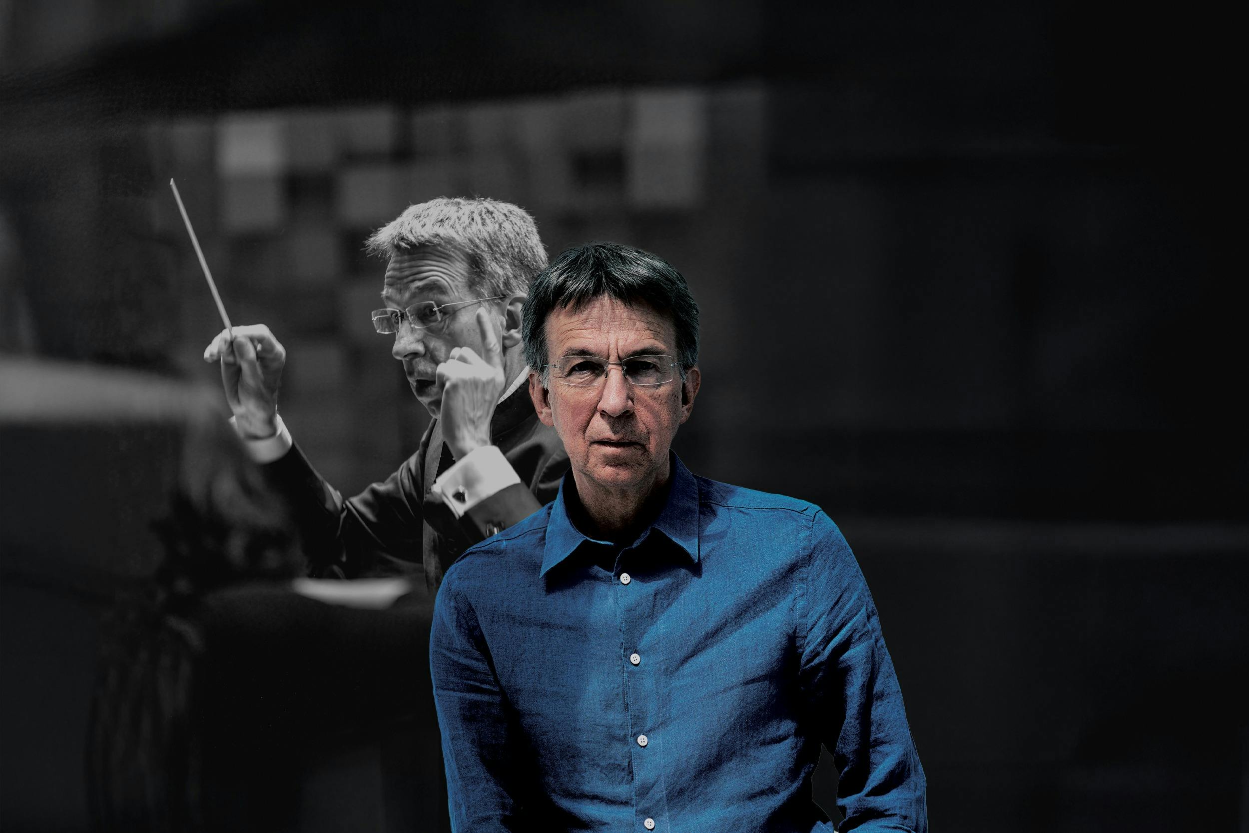 Eivind Aadland wearing glasses and a blue shirt stands in the foreground, facing the camera. Behind