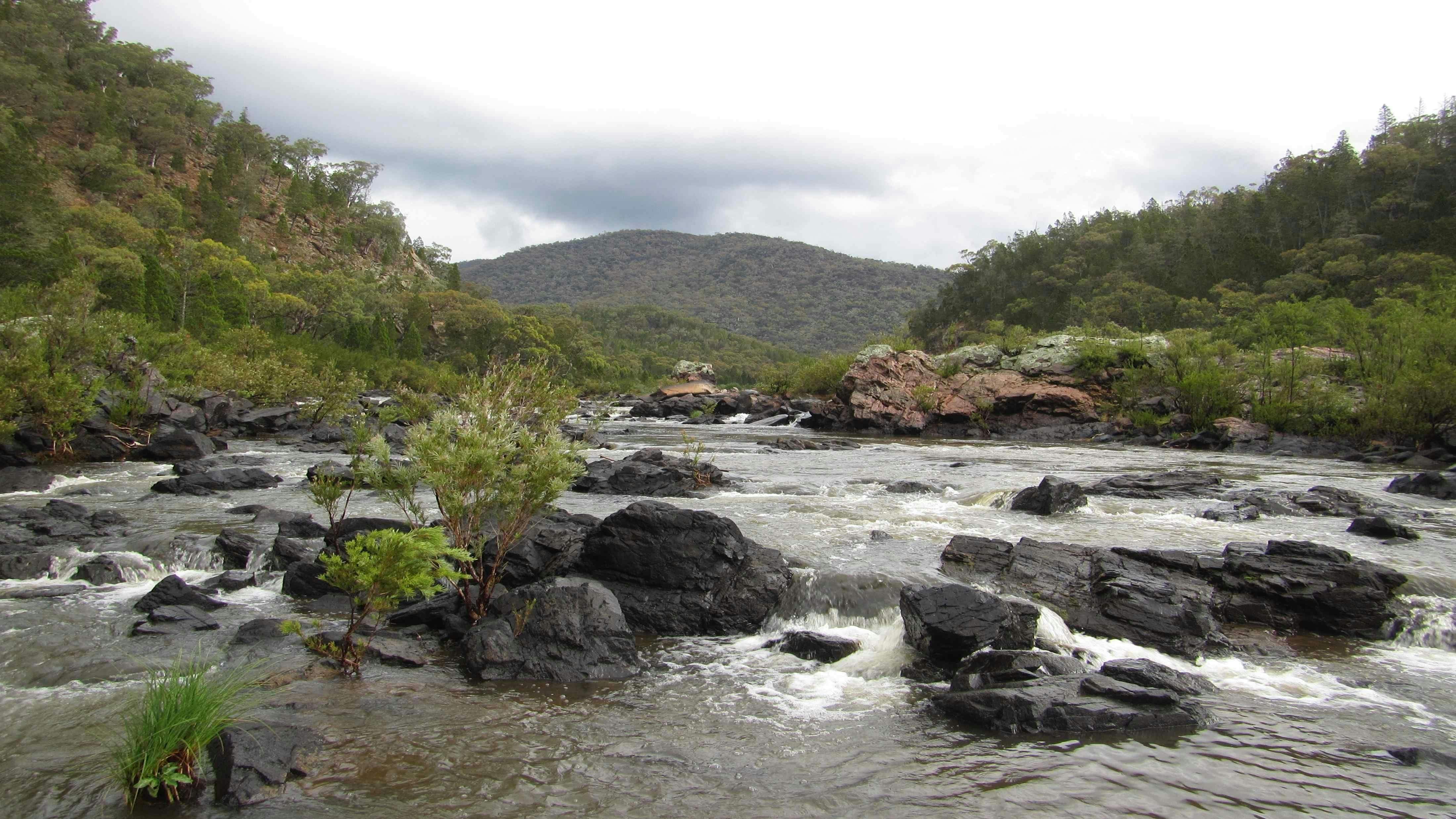 A picture of a waterwatch with rocks and hills in the background