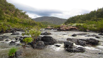 A picture of a waterwatch with rocks and hills in the background