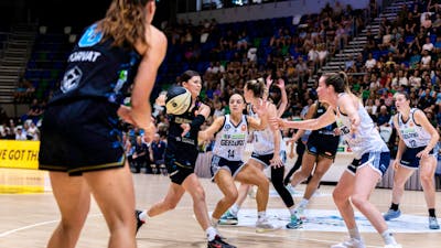 UC Capitals player passing the basketball during a game.