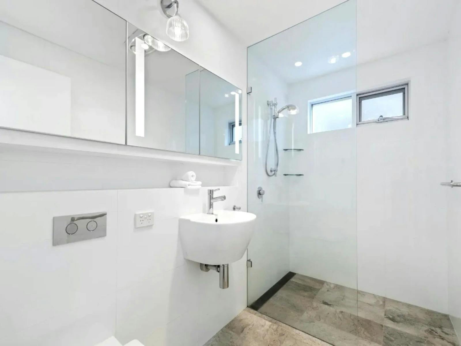 A modern bathroom with sleek fixtures and a spacious walk-in shower