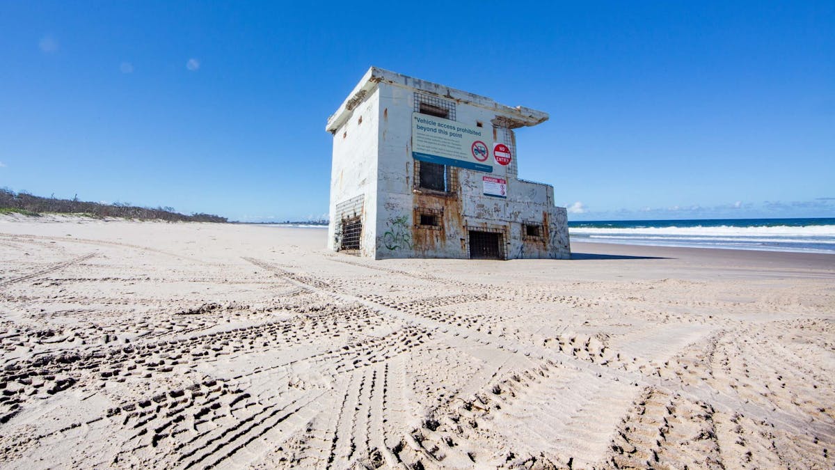 Part of Fort Bribie surrounded by 4WD tracks in the sand Part of Fort Bribie surrounded by 4WD tracks in the sand