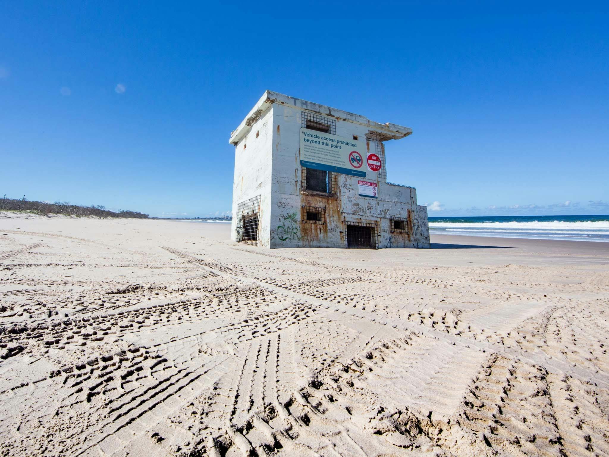 Part of Fort Bribie surrounded by 4WD tracks in the sand Part of Fort Bribie surrounded by 4WD tracks in the sand
