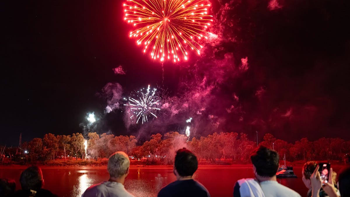 Fireworks exploding from the banks of the Fitzroy River.