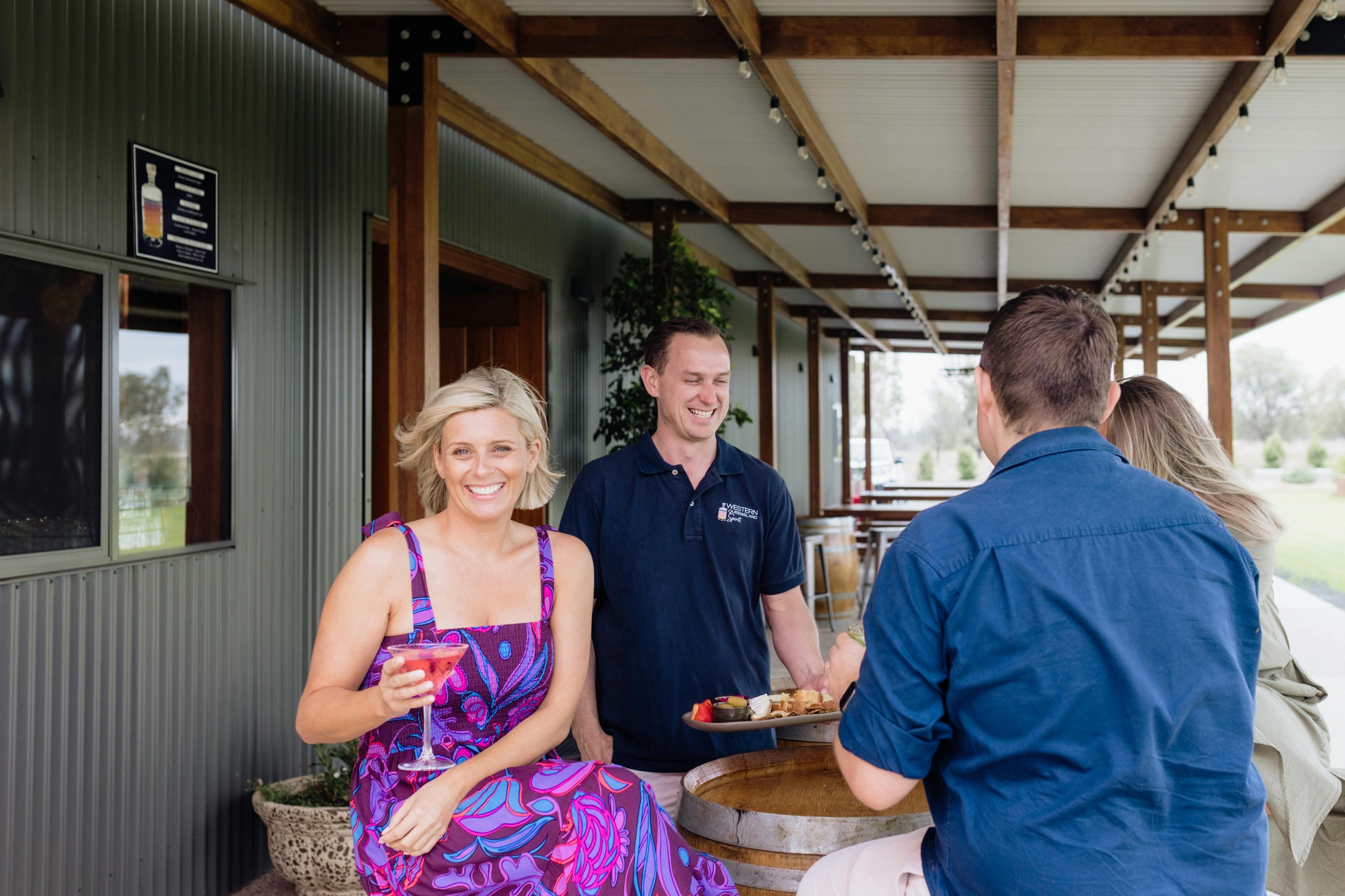 Guests enjoy cocktail on verandah