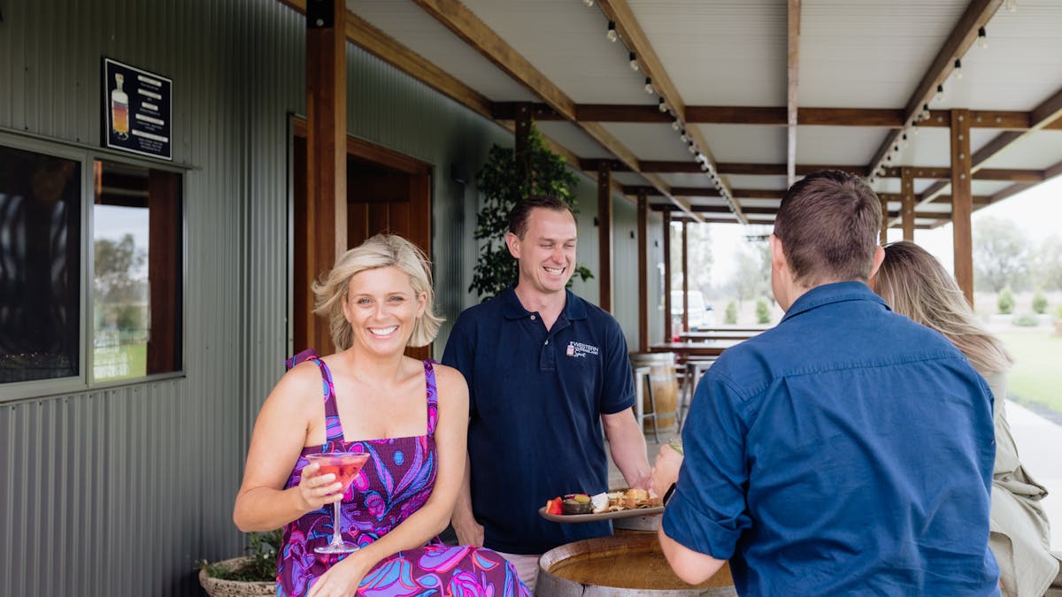 Guests enjoy cocktail on verandah