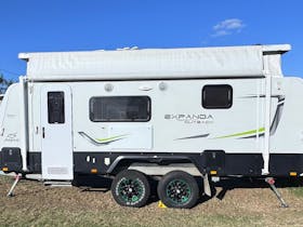 Jayco Expanda Outback with pop top roof open and both beds open. Awning is not extended.