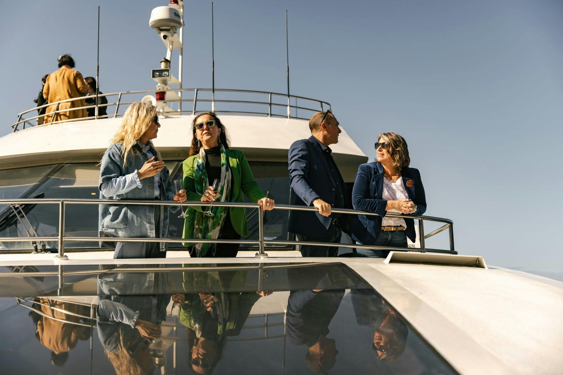 Groups of guests enjoying the views aboard catamaran