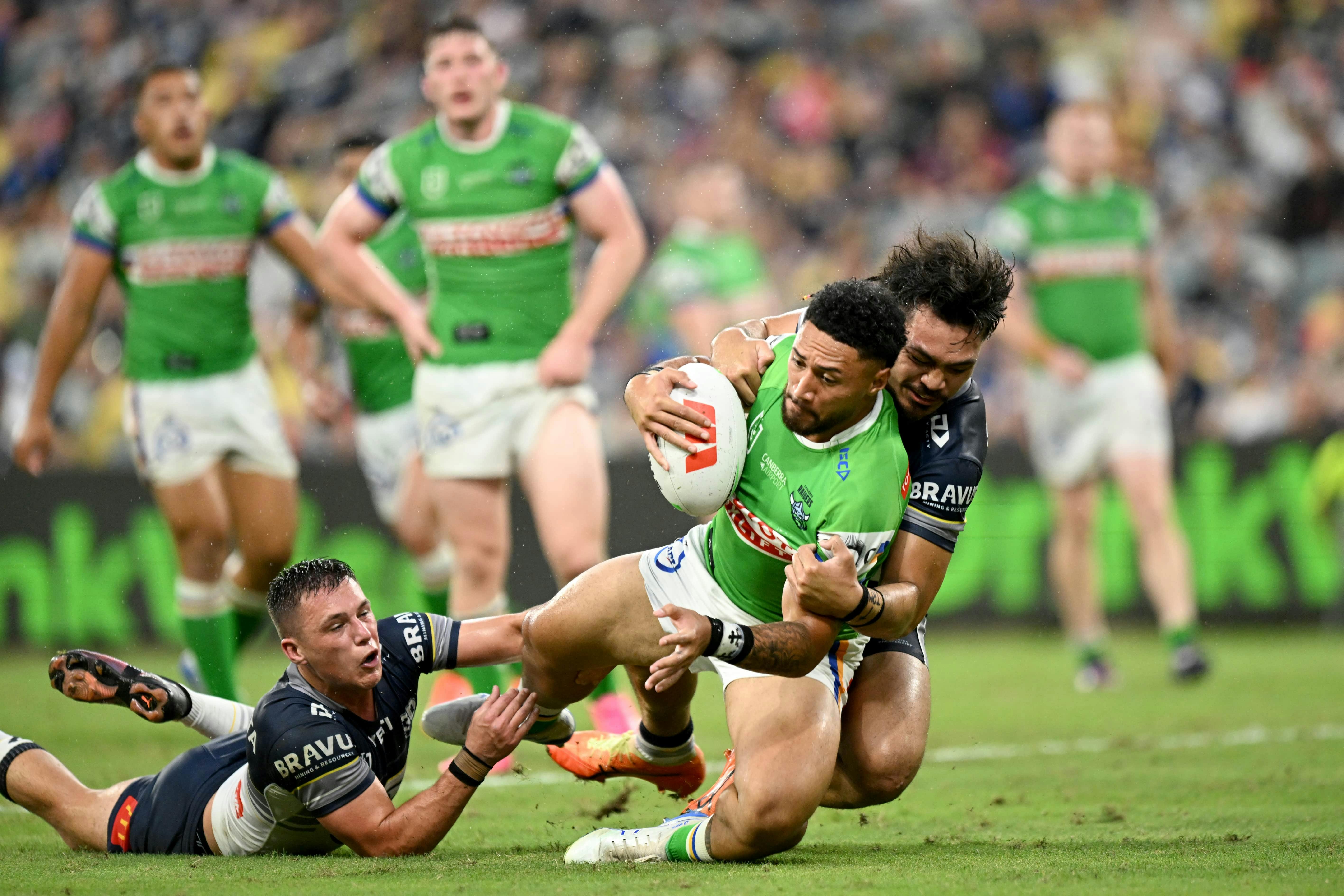 Canberra Raiders player Simi Sasagi being tackled.