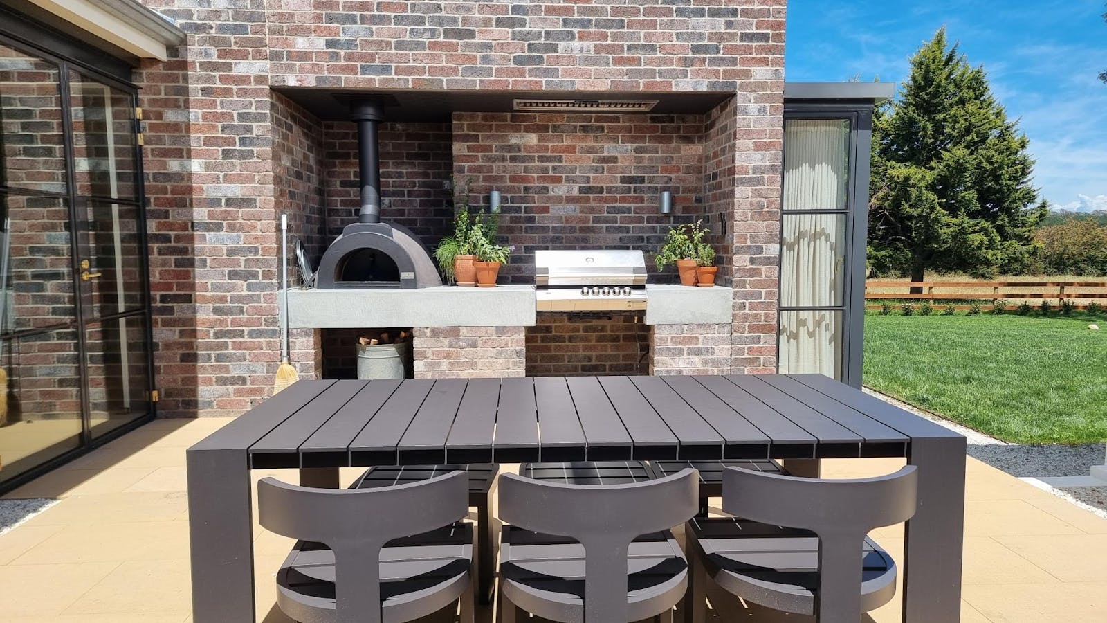 Internal coutyard featuring pizza oven, BBQ, sitting for 6 and herb garden.