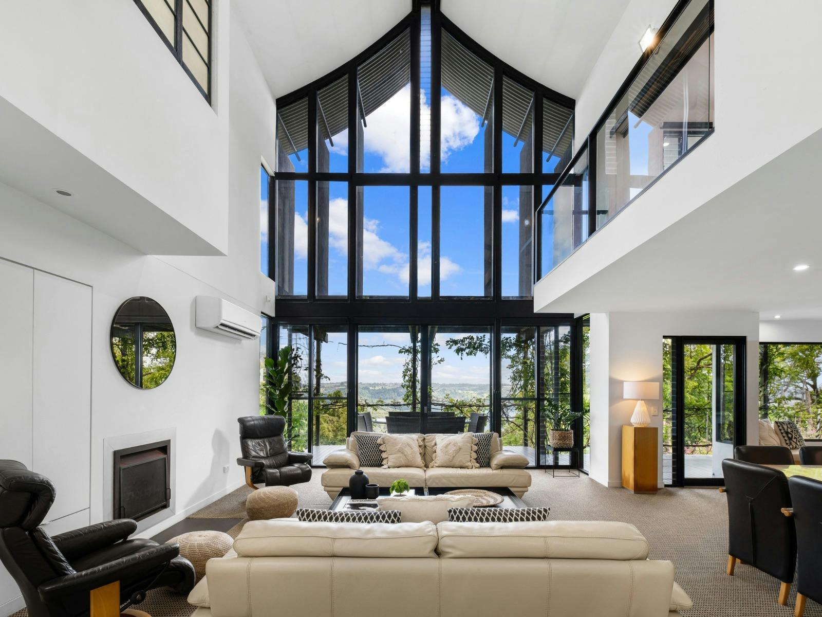 Living room with balcony access and sweeping views of Lake Baroon Living room with balcony access and sweeping views of Lake Baroon