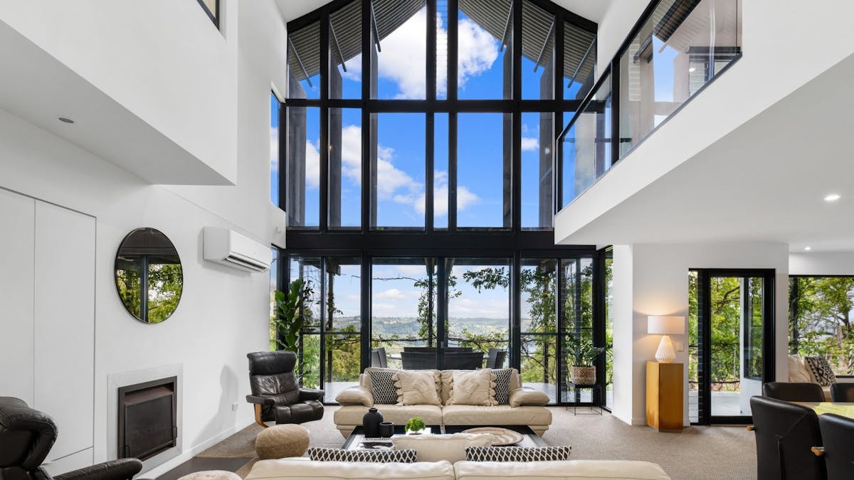 Living room with balcony access and sweeping views of Lake Baroon