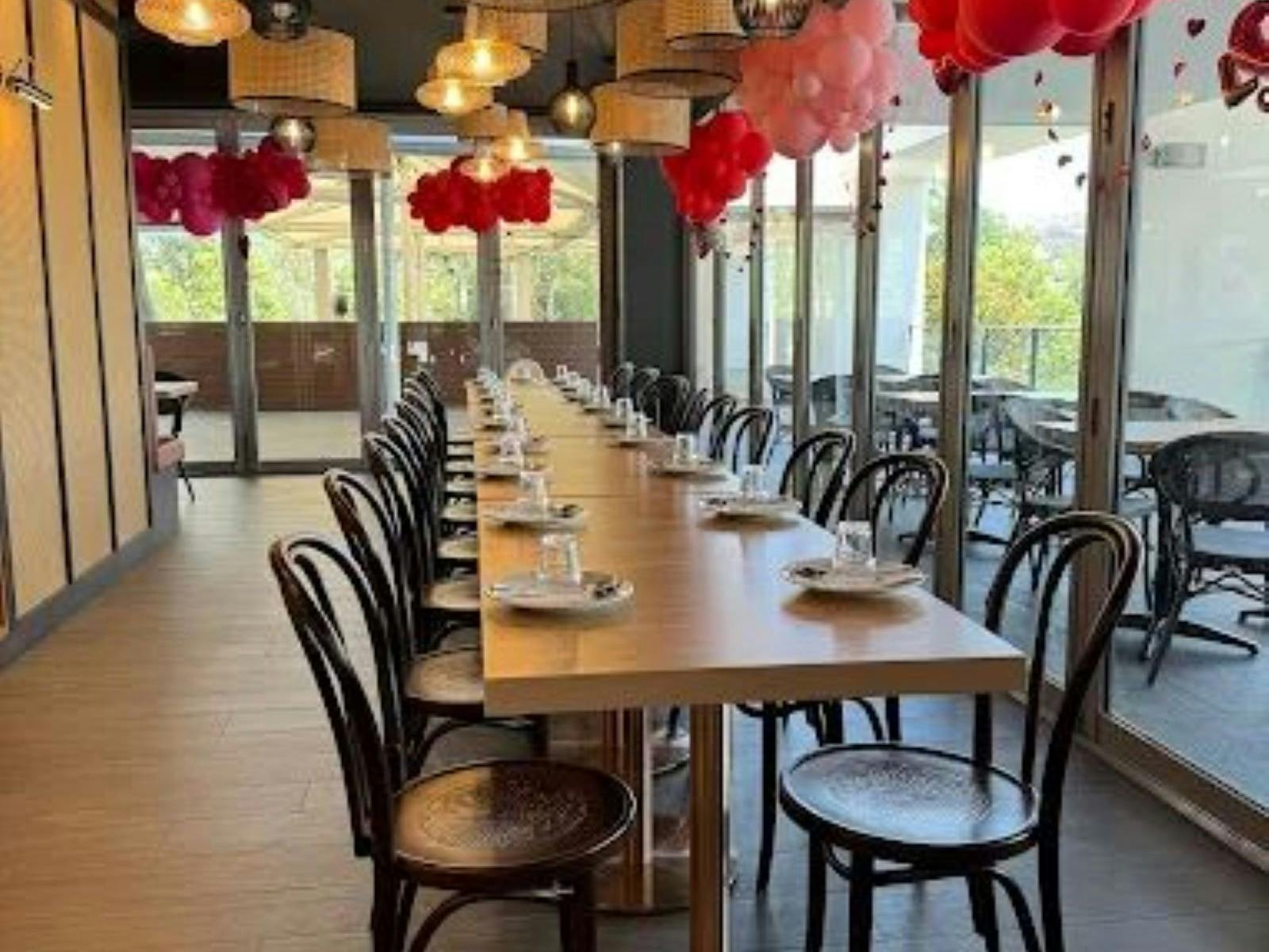 Tables and chairs setting inside Hude Thai Restaurant