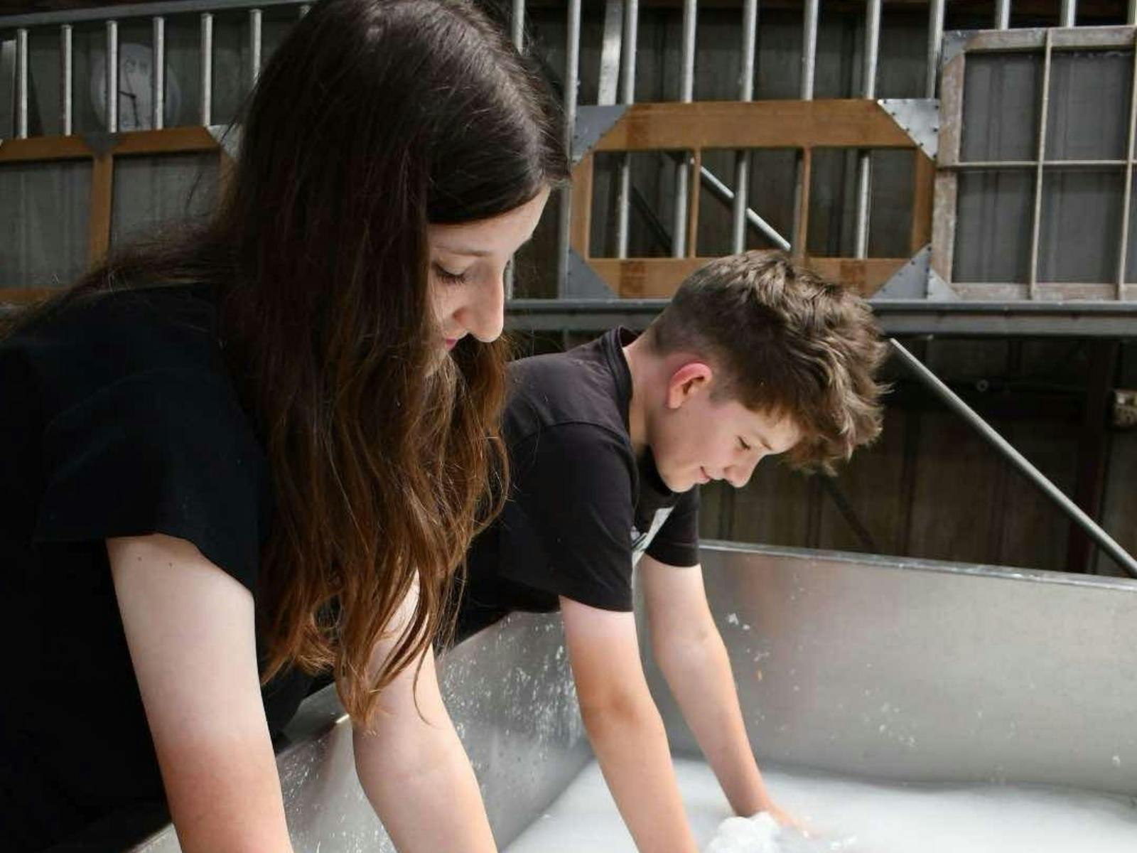 Children making their own sheets of paper.