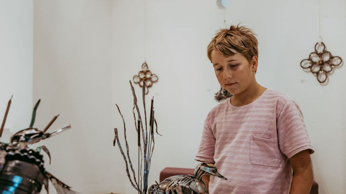 Young boy admiring a small duck sculpture at the Goondiwindi Art Gallery Young boy admiring a small duck sculpture at the Goondiwindi Art Gallery