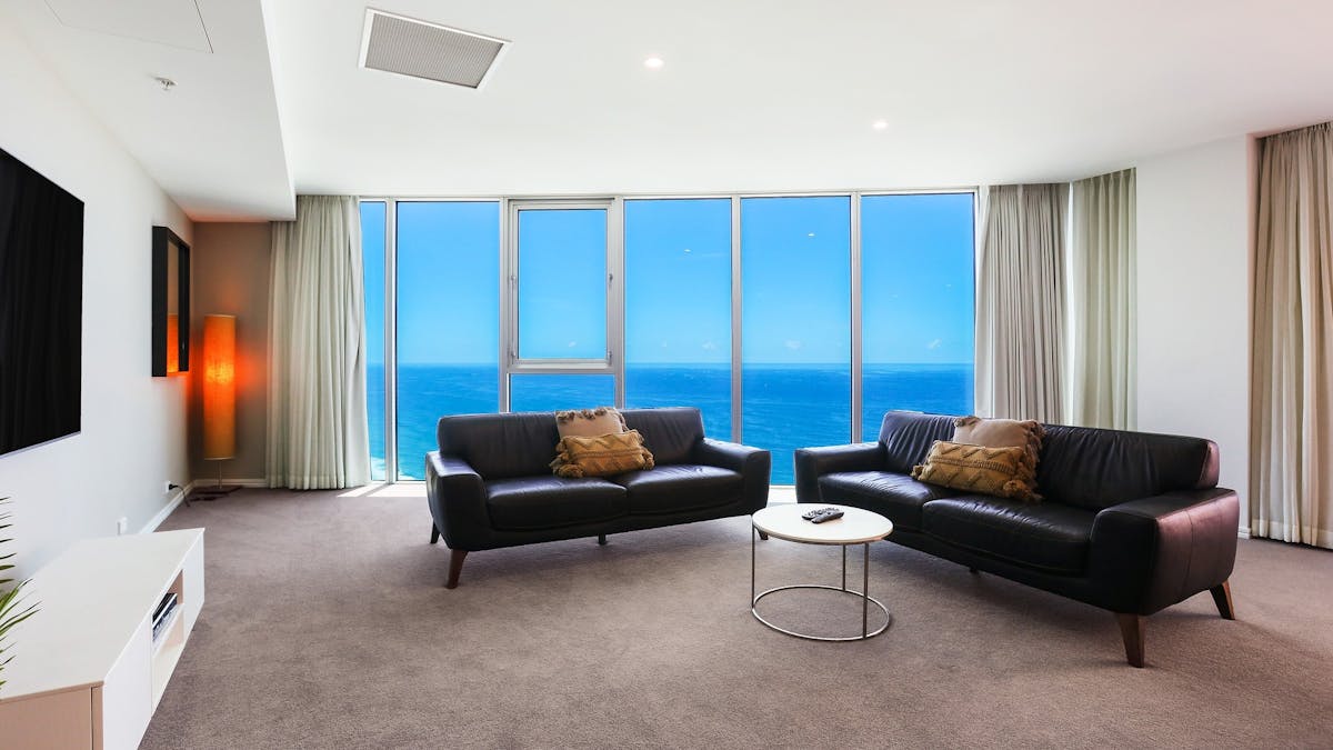 Spacious lounge room with ocean view background at the Hilton Surfers Paradise - Gold Coast Holidays