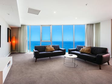 Spacious lounge room with ocean view background at the Hilton Surfers Paradise - Gold Coast Holidays