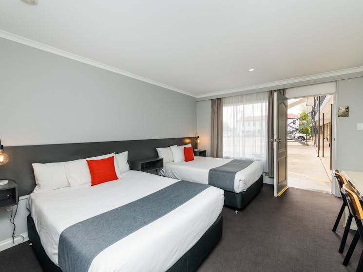 Twin Double Room layout, featuring two double beds, desk, kitchenette and modern design.