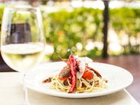 Linguini Pepperincino with red claw and a glass of wine