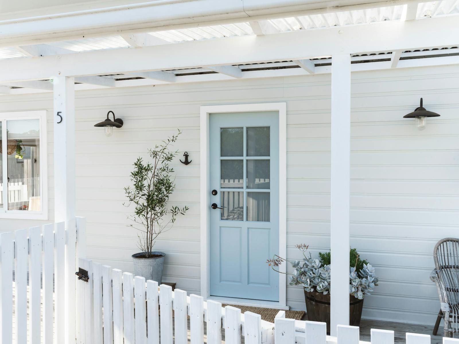 Front exterior of beach shack with blue door