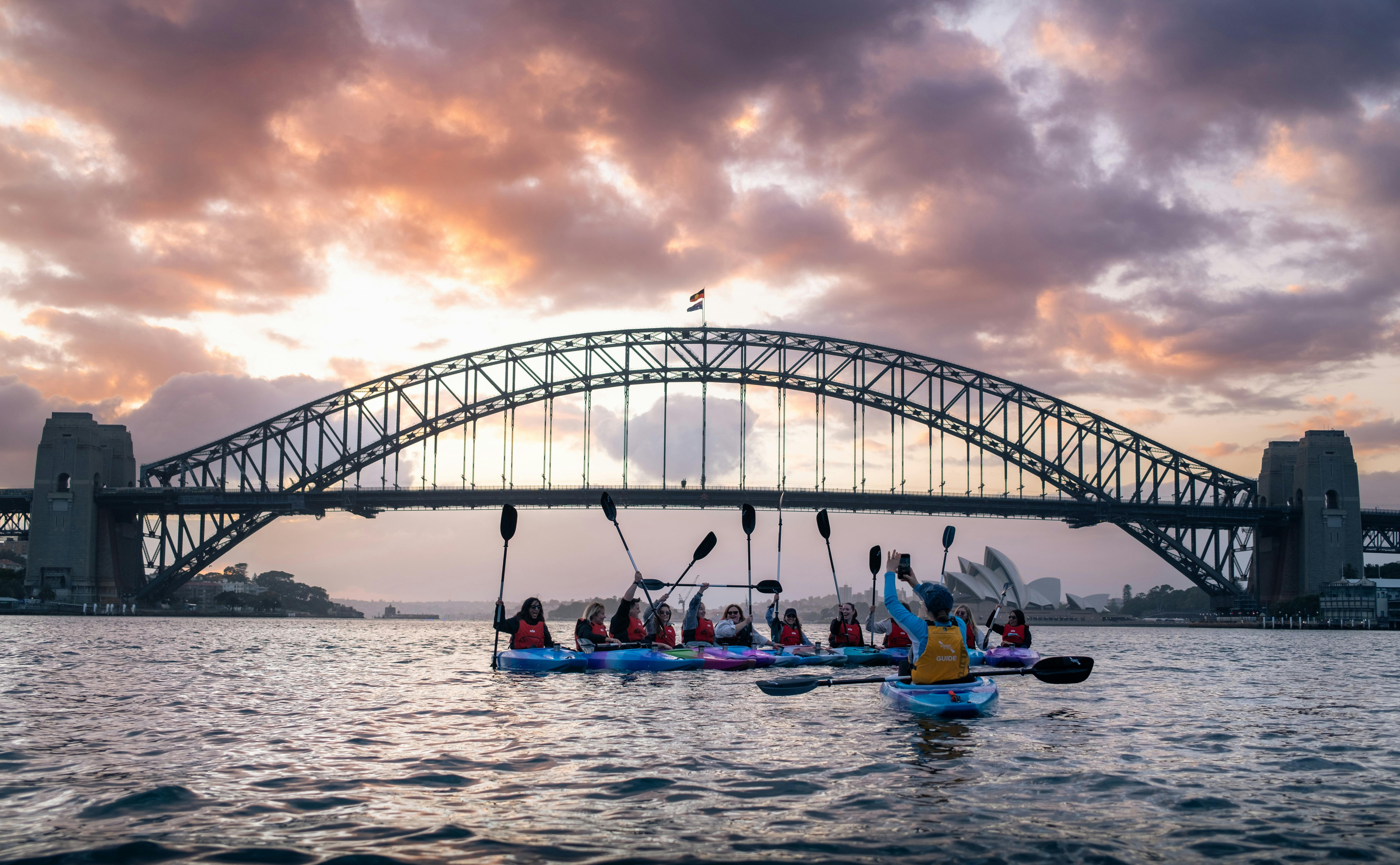 Founder of Sydney by Kayak Laura Stone takes free photos of customers with Opera House and Bridge.