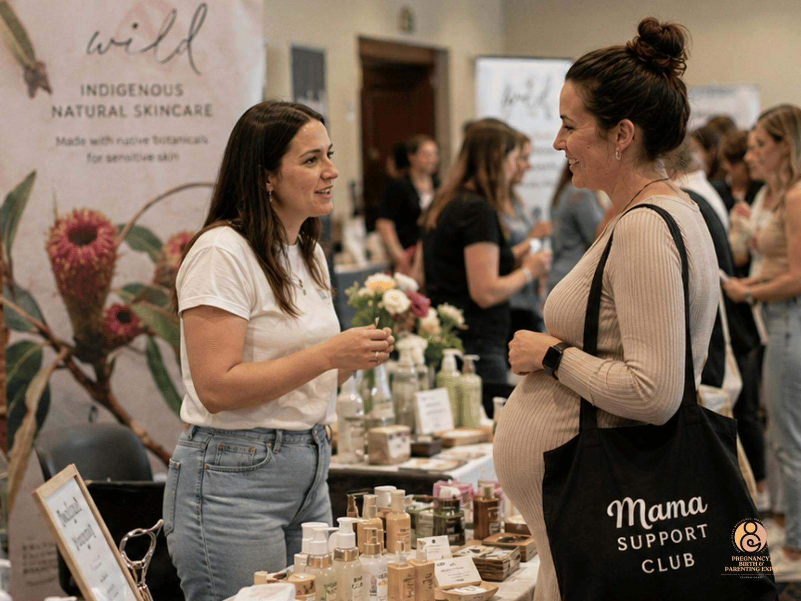 amilies exploring pregnancy and parenting exhibitor stalls in Gosford