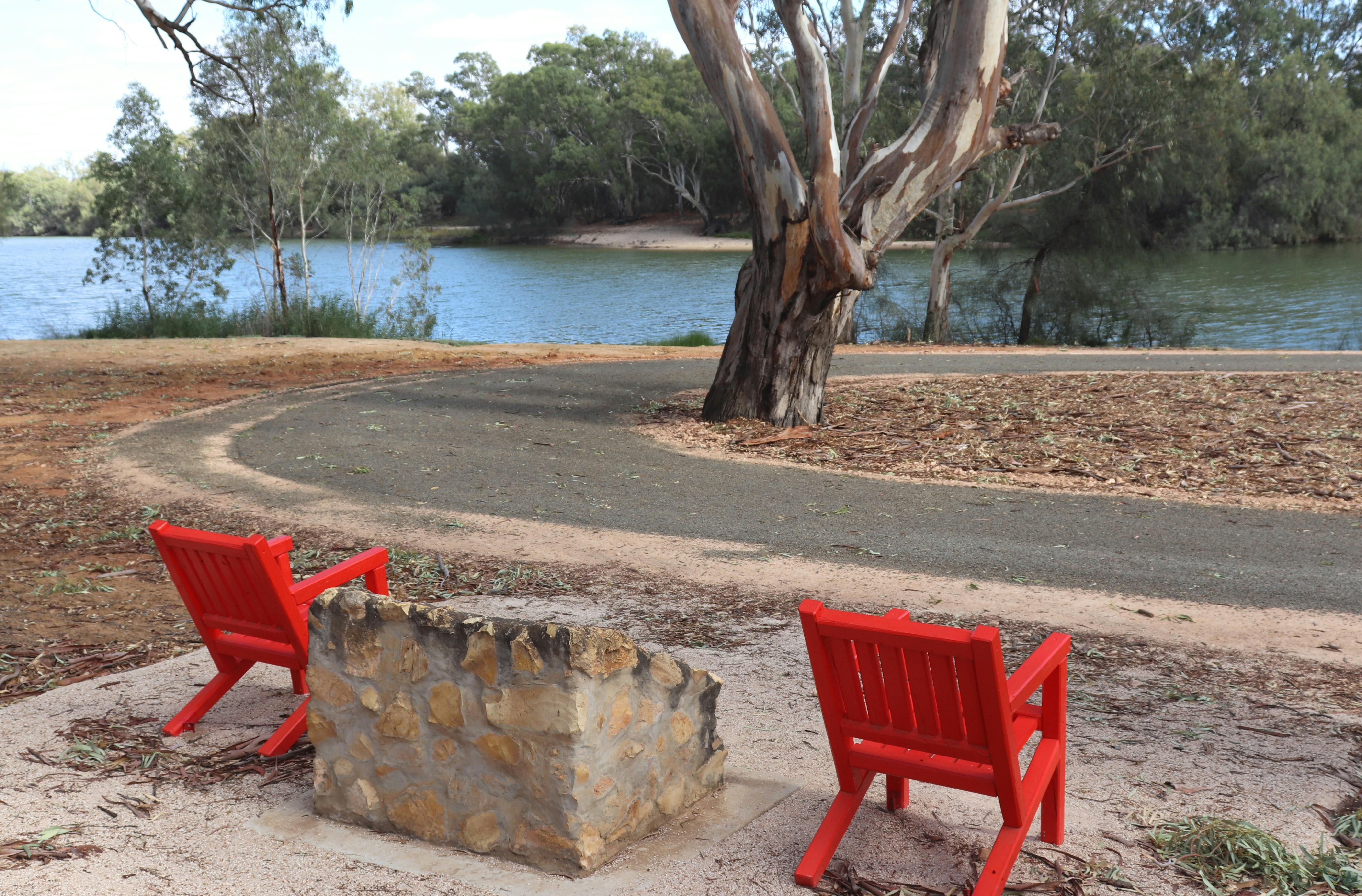 A pair of #riverredchairs sits next to the Habel's Bend monument.