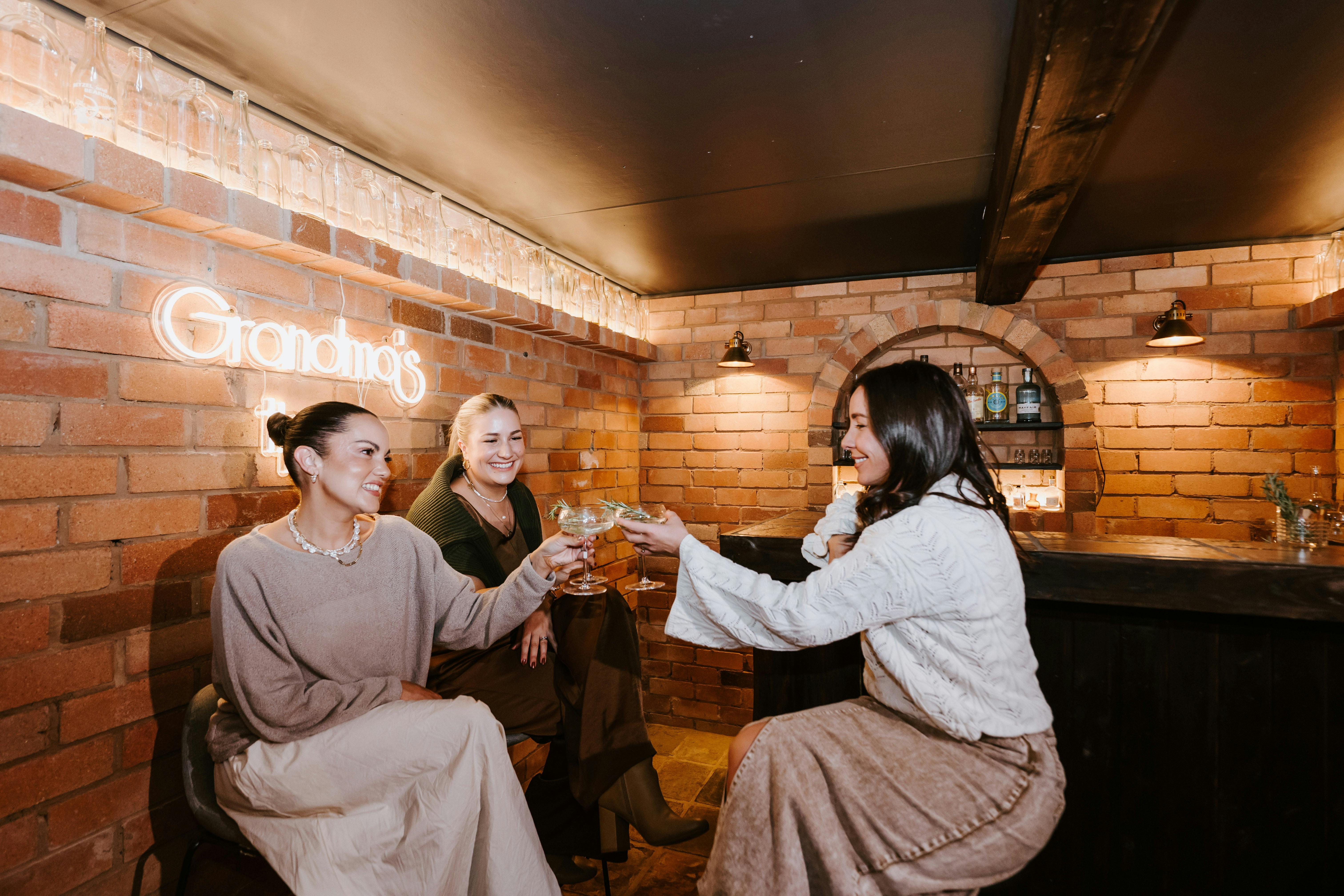 Women saying Cheers is the private underground bar