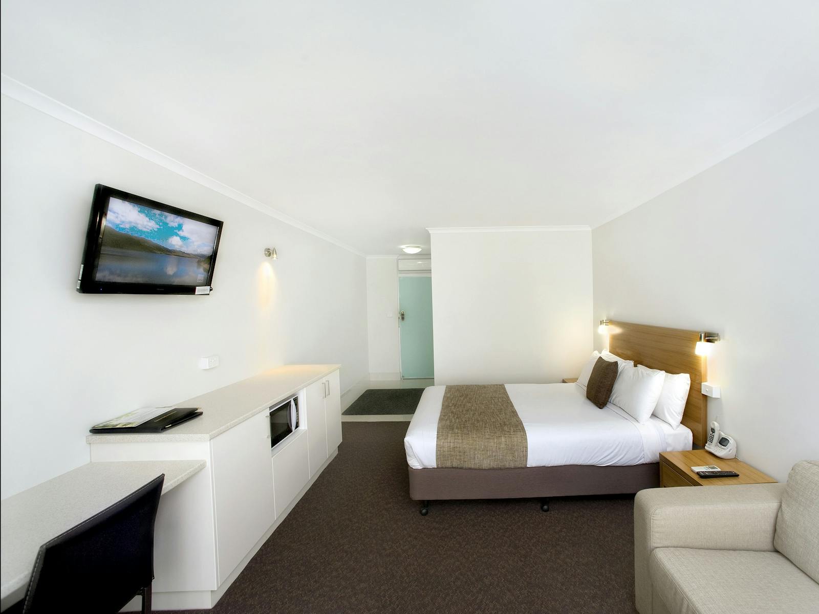 This room has a queen bed, kettle, toaster, microwave, sofa, desk, TV with free foxtel