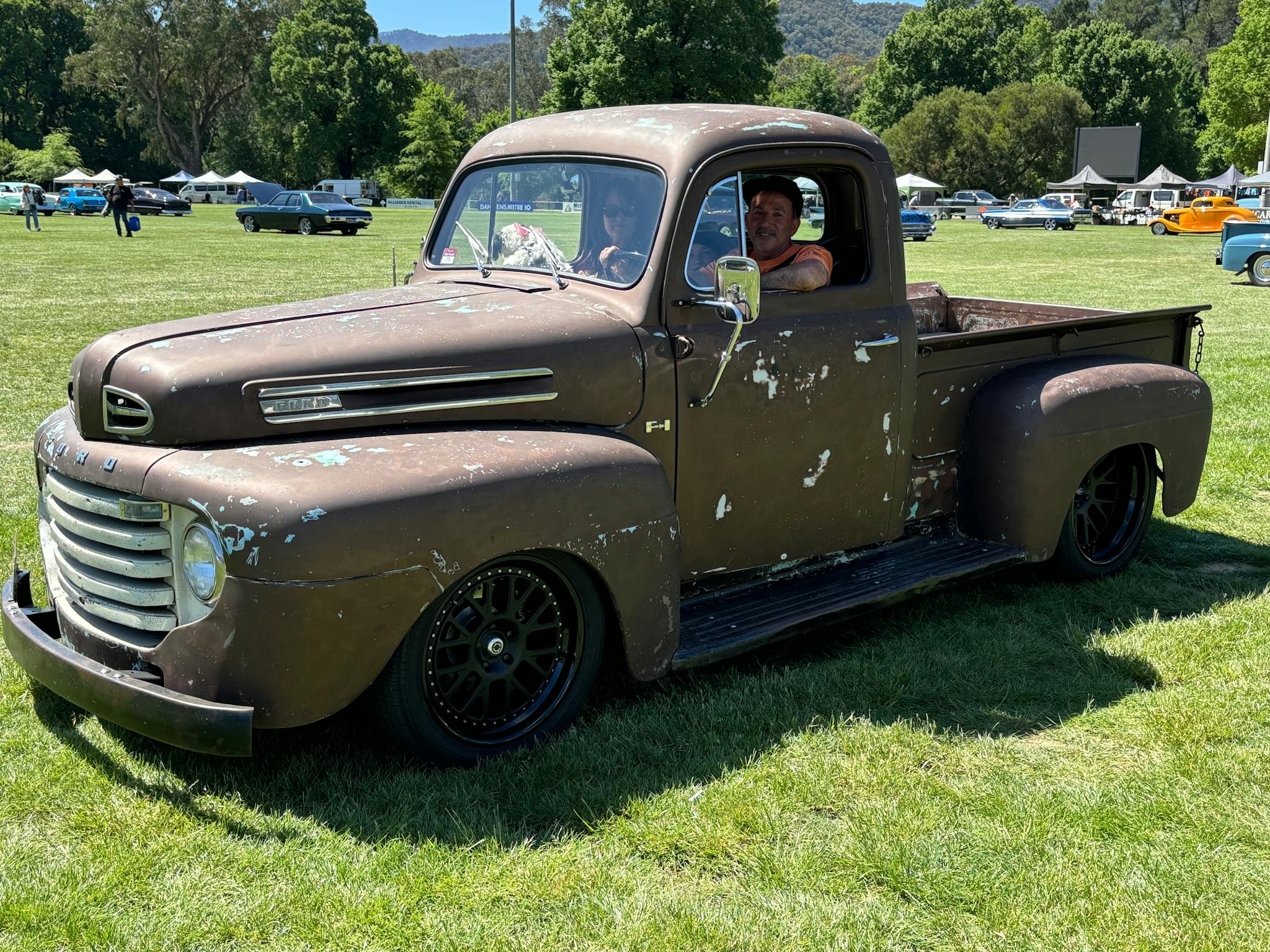 Two people in a brown truck